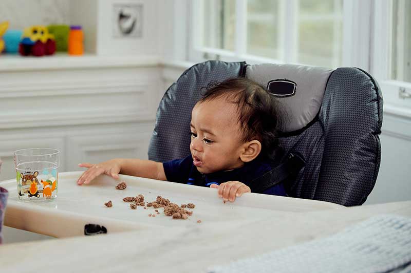 infant eating ground meat